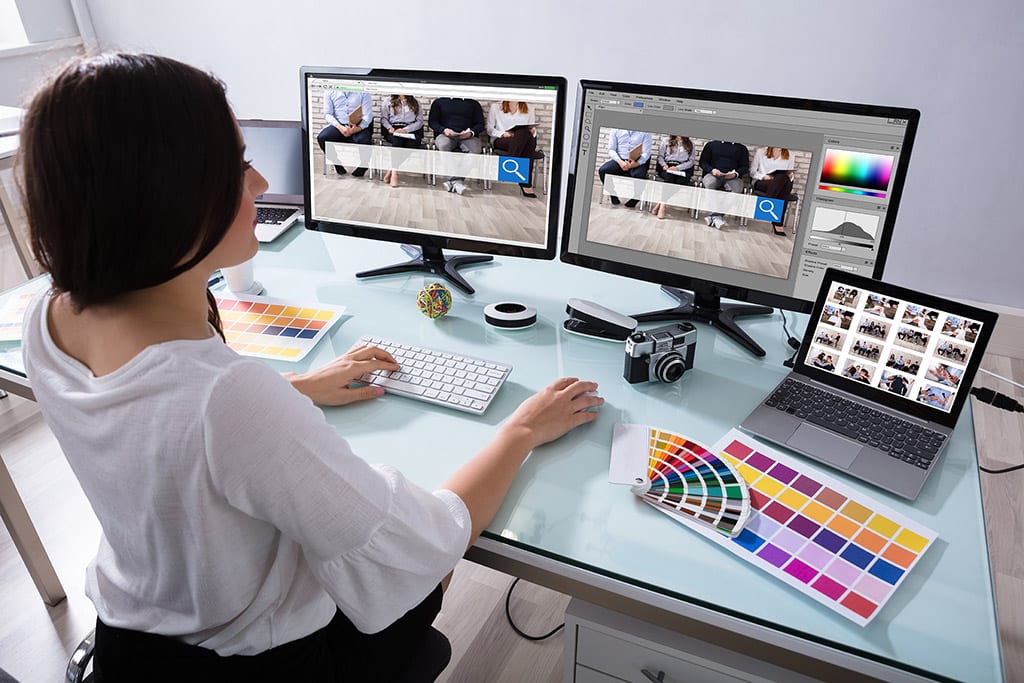 web designer sat at computer monitor